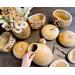This image shows unfinished gourds with their tops cut off. The gourds are dried and ready for carving.